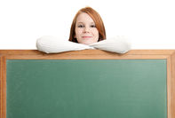 Shot for stock photography. A teenage girl leans on a blank chalkboard with room for copy.Click to enlarge photo